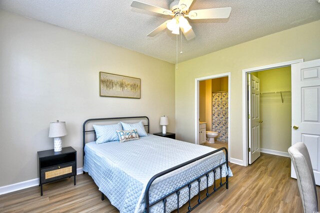5801 Oyster Catcher Dr Unit 723, North Myrtle Beach, SC 29582 - unfurnished bedroom featuring baseboards, a textured ceiling, light wood-style flooring, and ensuite bath