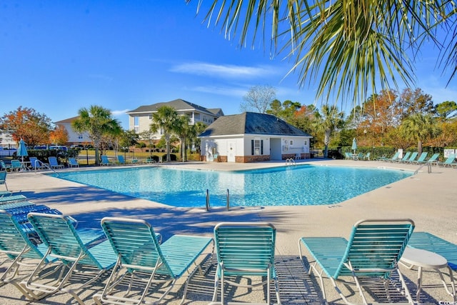 pool with fence and a patio area