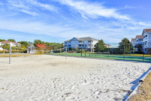 view of property's community with volleyball court and fence