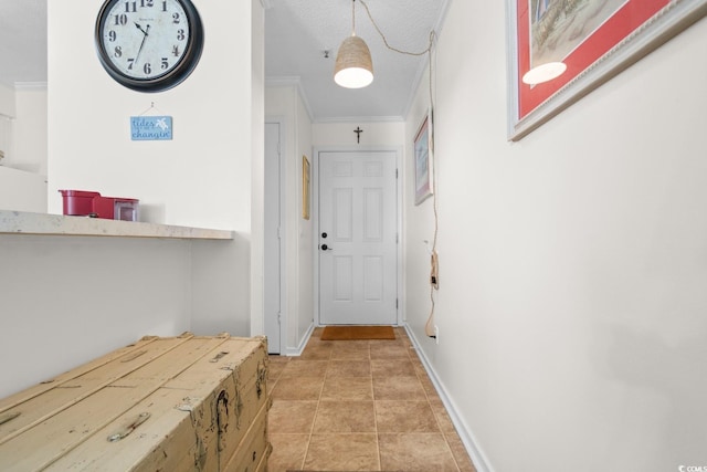 hall with crown molding, a textured ceiling, baseboards, and light tile patterned floors