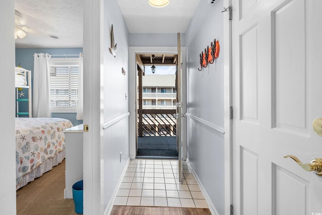 doorway featuring visible vents and a textured ceiling