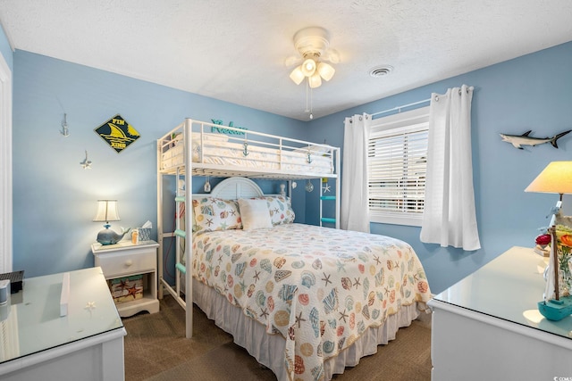 bedroom featuring a textured ceiling, carpet, and visible vents