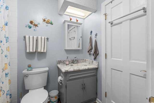 bathroom featuring toilet, a shower with curtain, and vanity