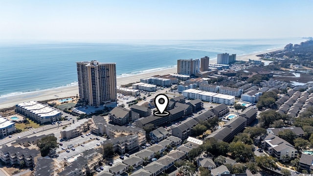 birds eye view of property with a water view, a view of city, and a view of the beach