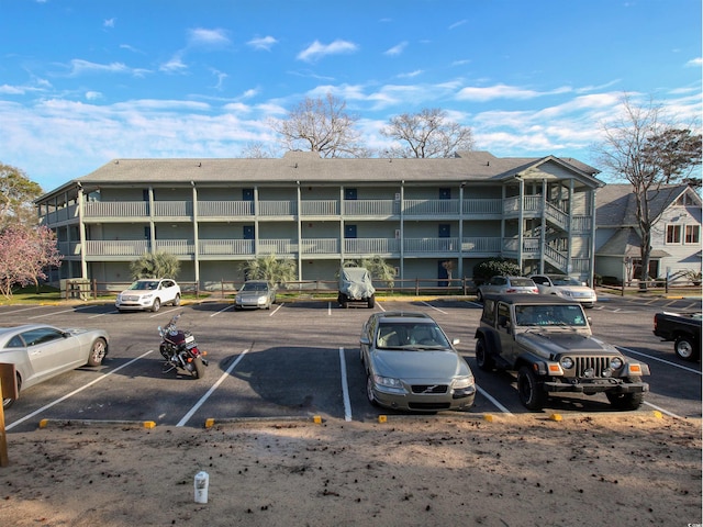 view of building exterior with uncovered parking