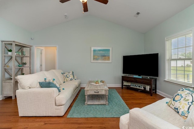 living area with a ceiling fan, lofted ceiling, wood finished floors, and baseboards