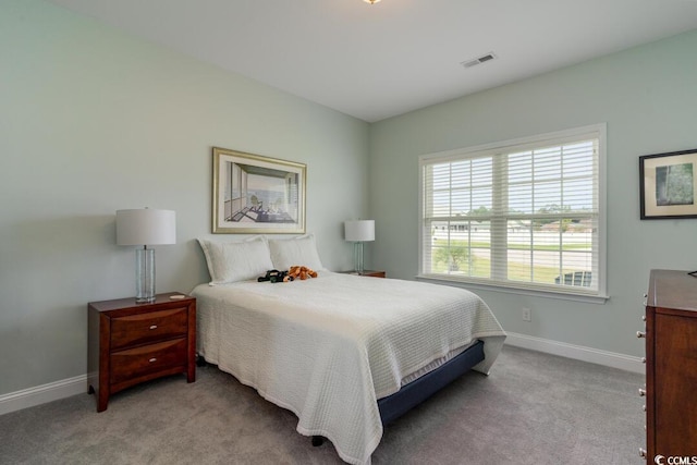 carpeted bedroom featuring baseboards