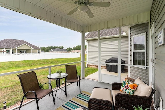 sunroom / solarium featuring ceiling fan