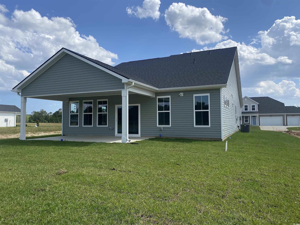 242 Letha Dr, Longs, SC 29568 - rear view of house featuring a lawn, central air condition unit, a patio area, and roof with shingles