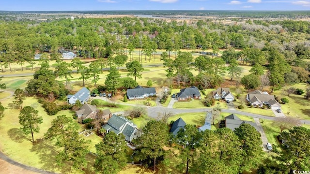 bird's eye view featuring a wooded view and a residential view