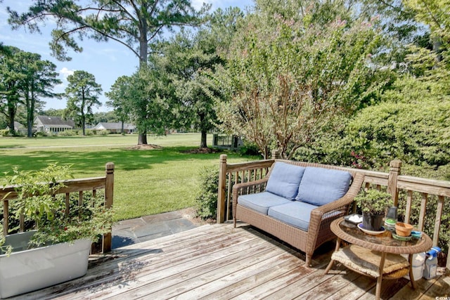 wooden terrace featuring a lawn and outdoor lounge area