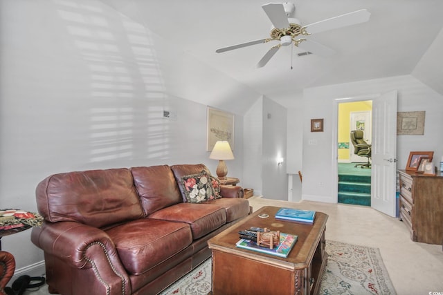 living area with baseboards, ceiling fan, and vaulted ceiling