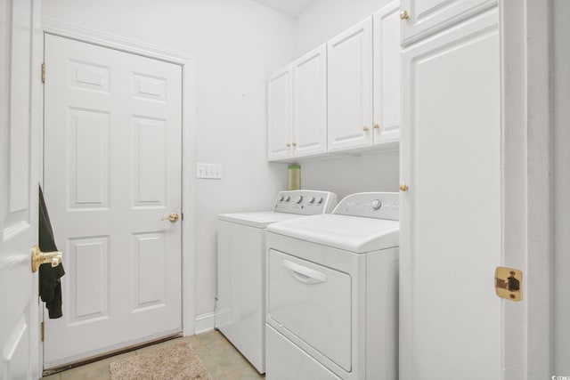 clothes washing area featuring cabinet space and independent washer and dryer