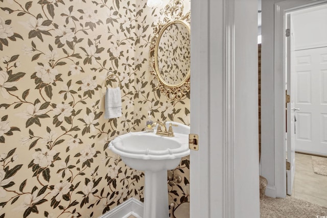 bathroom with wallpapered walls