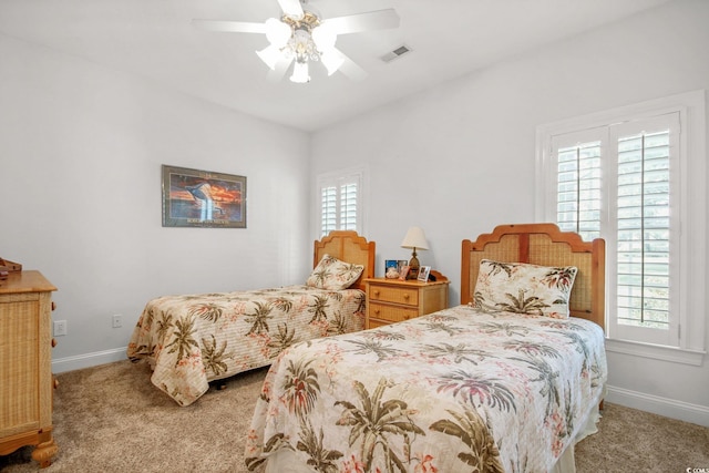 carpeted bedroom featuring visible vents, multiple windows, and baseboards