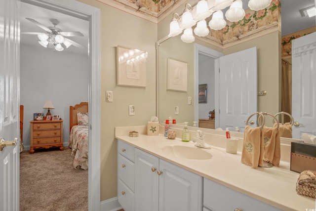 bathroom with baseboards, a ceiling fan, and vanity