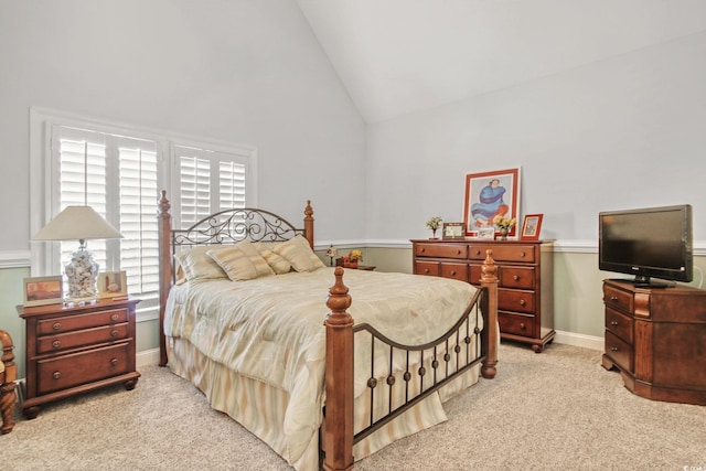 bedroom with light carpet, baseboards, and lofted ceiling