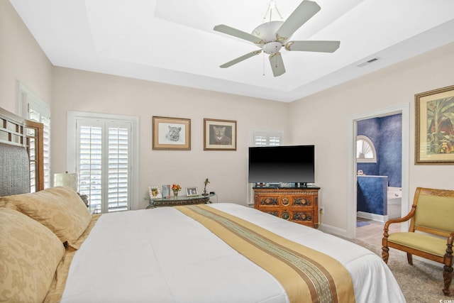 bedroom with visible vents, a ceiling fan, a raised ceiling, and baseboards