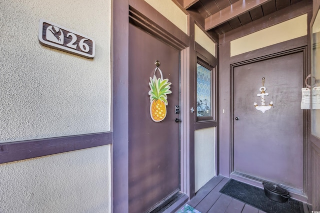 property entrance featuring stucco siding