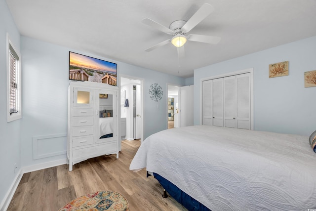 bedroom featuring ceiling fan, a closet, light wood-style flooring, and baseboards