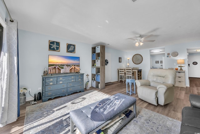 living area featuring ceiling fan and wood finished floors