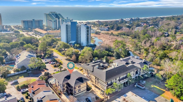 birds eye view of property featuring a view of city and a water view