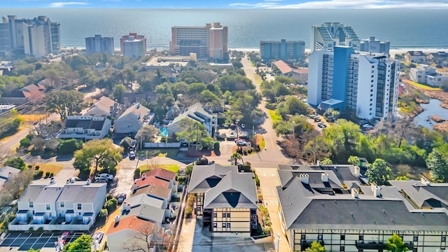 drone / aerial view featuring a water view and a city view