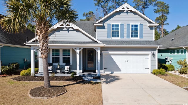 view of front of house with covered porch, concrete driveway, a shingled roof, and a garage