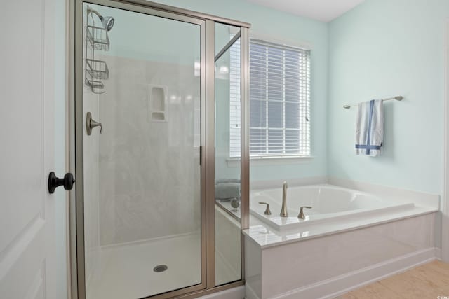 full bath with a garden tub, a shower stall, and tile patterned flooring