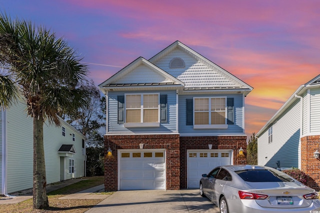 view of front facade with brick siding, driveway, and an attached garage