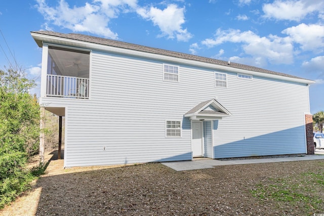 back of property featuring a balcony