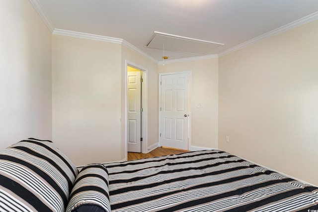 unfurnished bedroom featuring attic access, baseboards, and crown molding