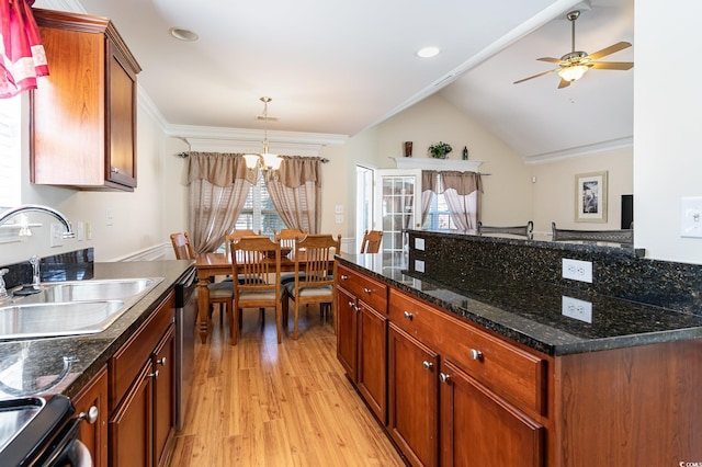 kitchen featuring ornamental molding, brown cabinets, vaulted ceiling, light wood-type flooring, and a sink