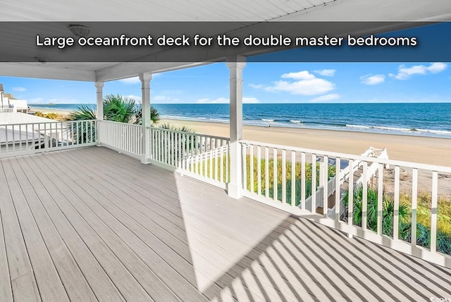 deck with a water view and a beach view