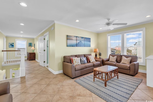 living area featuring light tile patterned floors, baseboards, ornamental molding, and a wealth of natural light