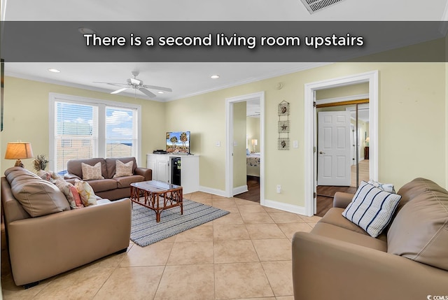 living room featuring crown molding, light tile patterned floors, recessed lighting, ceiling fan, and baseboards