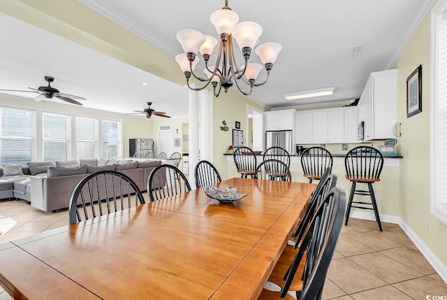 dining room with a chandelier, ornamental molding, light tile patterned flooring, and baseboards