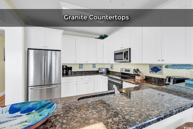 kitchen featuring stainless steel appliances, white cabinetry, and ornamental molding