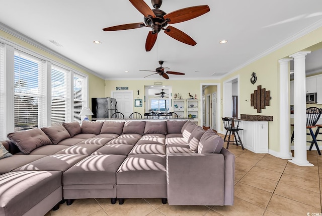 living room with light tile patterned floors, recessed lighting, visible vents, decorative columns, and crown molding