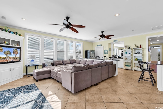 living area with ornamental molding, recessed lighting, visible vents, and light tile patterned floors