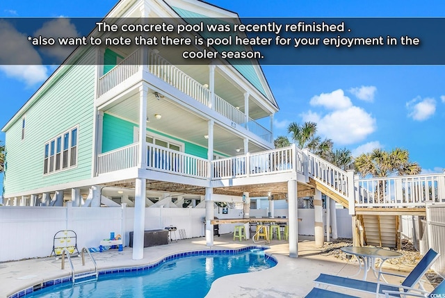 rear view of property featuring stairs, fence, a fenced in pool, and a patio