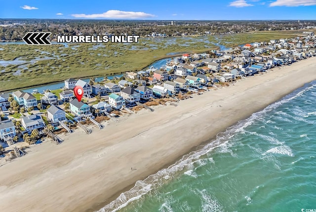 birds eye view of property with a view of the beach, a residential view, and a water view