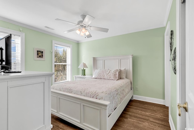 bedroom featuring multiple windows, visible vents, dark wood finished floors, and crown molding