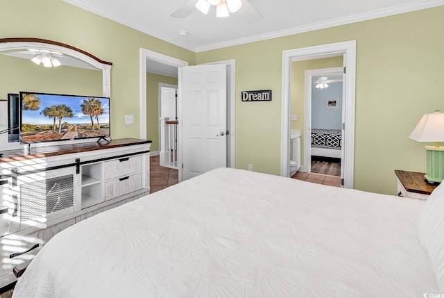 tiled bedroom featuring ornamental molding, a ceiling fan, and ensuite bathroom