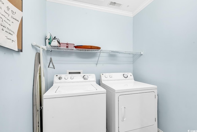 laundry area featuring ornamental molding, washer and dryer, laundry area, and visible vents