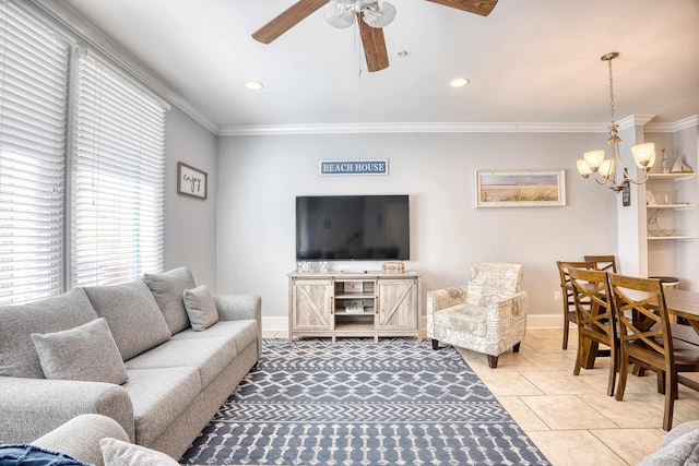 living area with baseboards, ornamental molding, and ceiling fan with notable chandelier