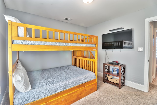 bedroom with carpet floors, visible vents, and baseboards