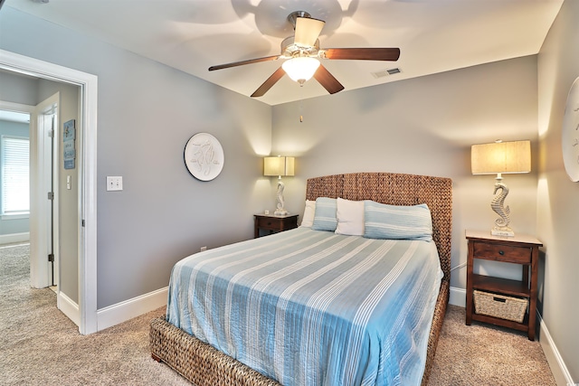 bedroom with carpet floors, baseboards, visible vents, and a ceiling fan