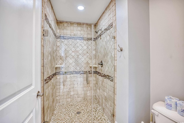 full bath with a stall shower and toilet