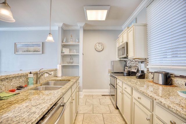 kitchen featuring appliances with stainless steel finishes, pendant lighting, a sink, and ornamental molding